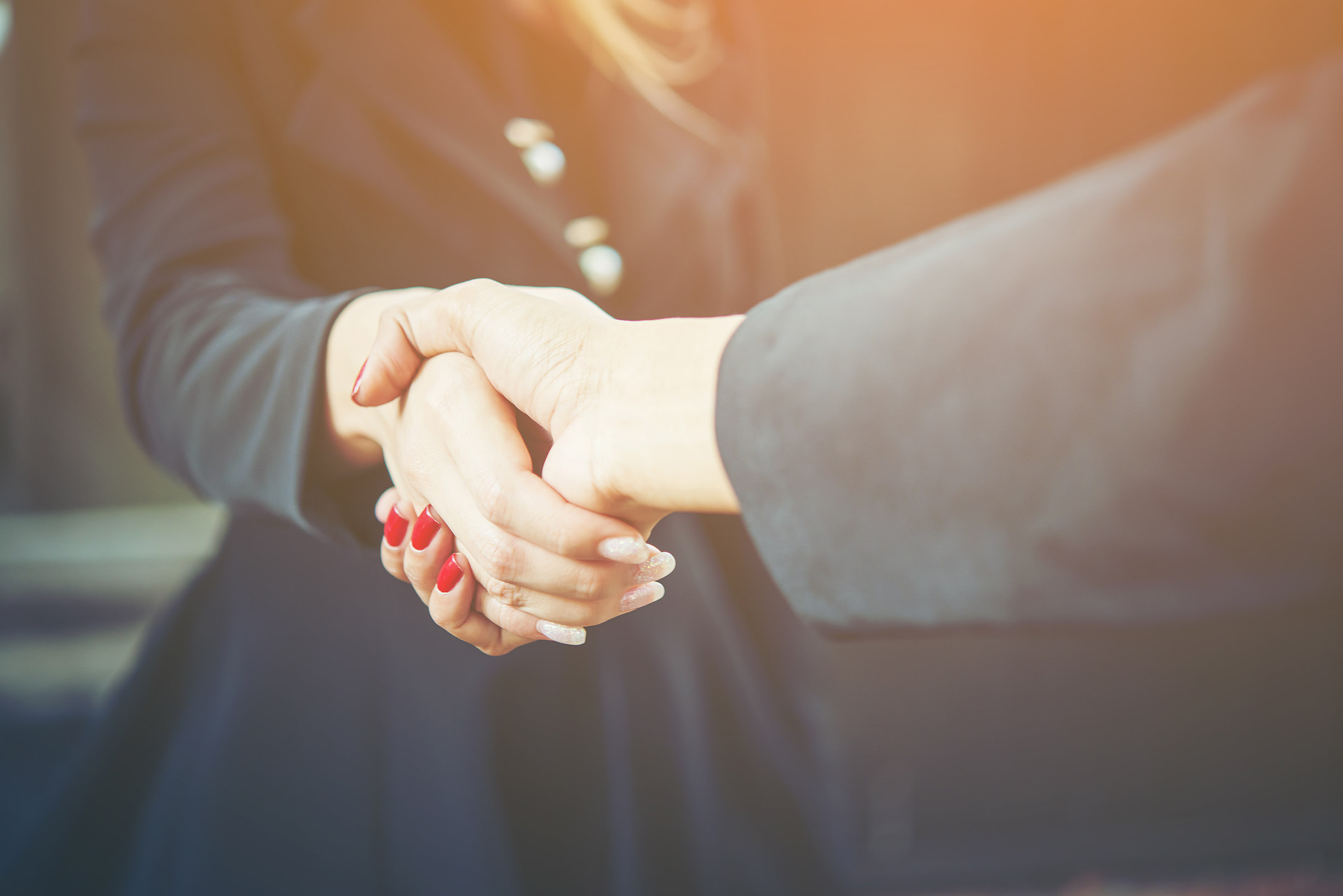 Close-up of business people shaking hands for completely busines